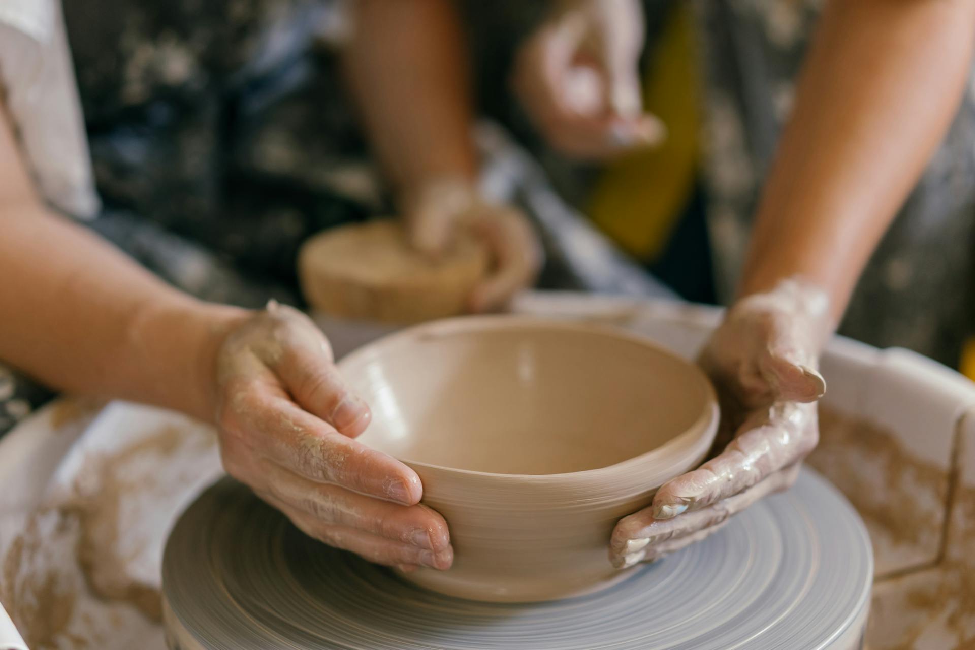 Person Shaping the Clay Using Hands
